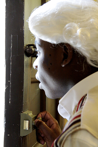 Student opening the door to Dr Johnson's House